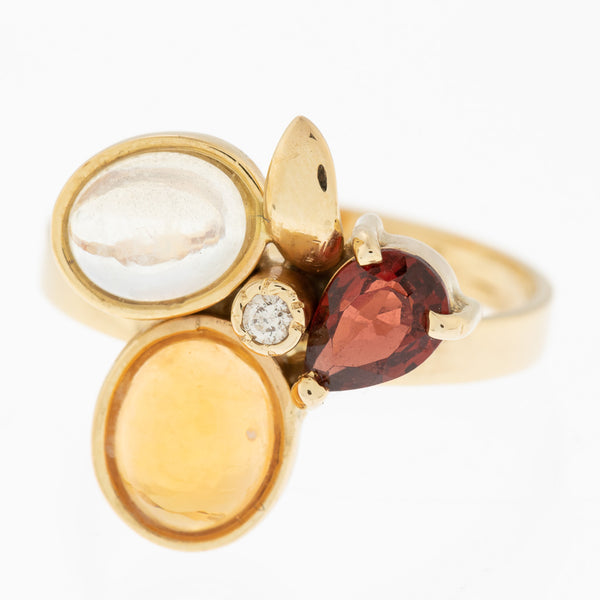 Juego de anillo y aretes diseño especial con diamantes, ópalos y granates en oro amarillo 14 kilates.