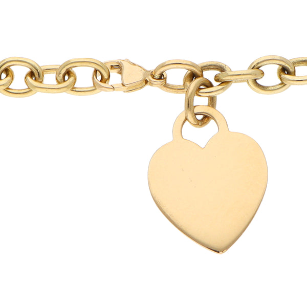 Pulsera eslabón cruzado con dije motivo corazón firma Tiffany & Co. en oro amarillo 18 kilates.