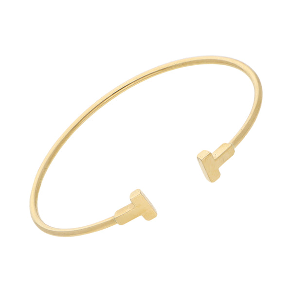 Pulsera de arillo abierta firma Tiffany & Co. colección T en oro amarillo 18 kilates.