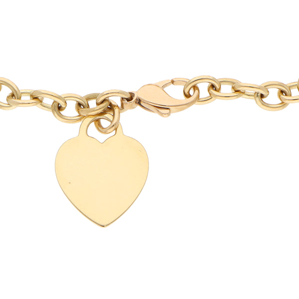 Pulsera eslabón combinado con dije motivo corazón firma Tiffany & Co. en oro amarillo 18 kilates.