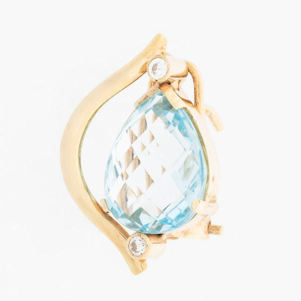 Aretes estilizados con diamantes y topacio azul en oro amarillo 14 kilates.