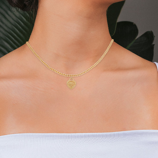 Gargantilla eslabón boleado con colgante motivo corazón firma Tiffany & Co. en oro amarillo 18 kilates.