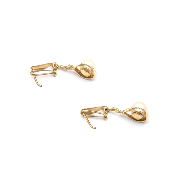 Aretes estilizados con perlas y circonias en oro amarillo 14 kilates.