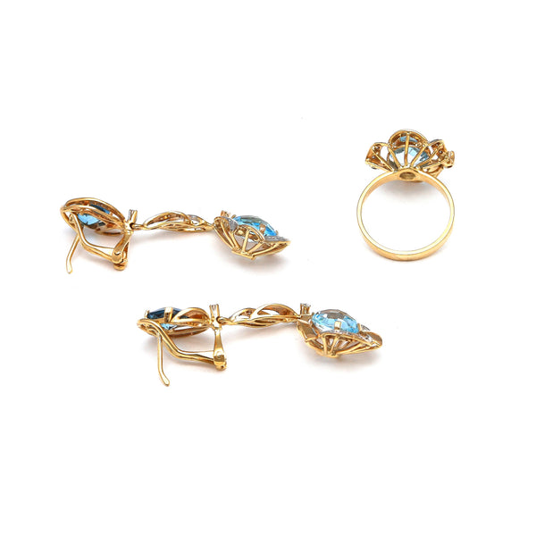 Juego de anillo y aretes estilizados con colgantes, diamantes y topacios London blue en oro amarillo 14 kilates.