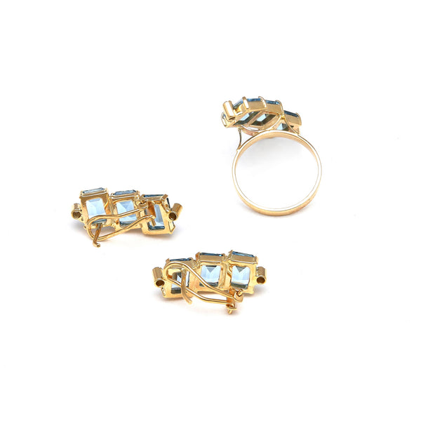 Juego de anillo y aretes estilizados con diamantes y topacios azules en oro amarillo 14 kilates.