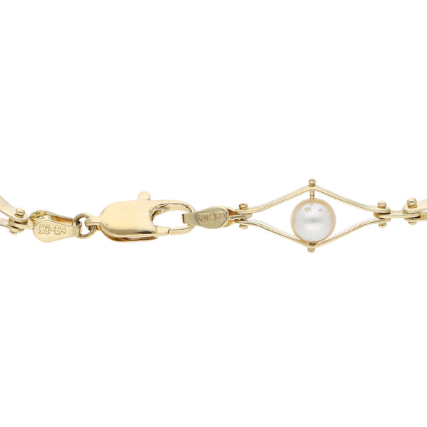 Pulsera eslabón combinado con perlas en oro amarillo 14 kilates.