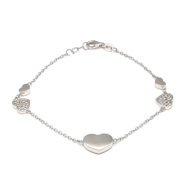 Pulsera eslabón cruzado motivo corazones con circonias en oro blanco 14 kilates.