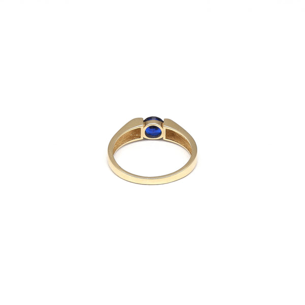 Anillo diseño especial con circonia azul en oro amarillo 14 kilates.