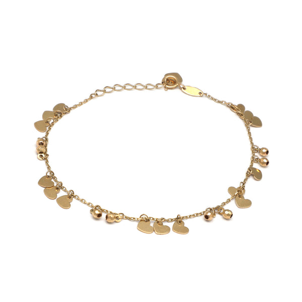 Pulsera eslabón cruzado con esferas y colgantes motivo corazones en oro amarillo 14 kilates.