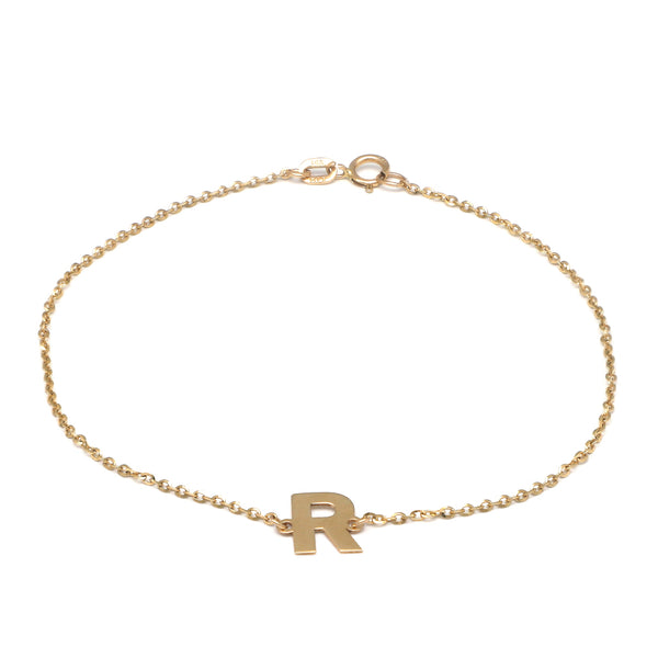 Pulsera eslabón cruzado con aplicación motivo letra R en oro amarillo 14 kilates.