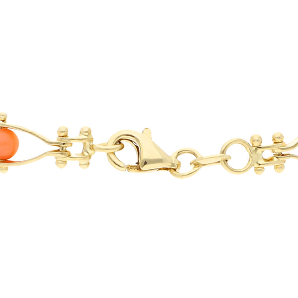 Pulsera eslabón combinado con coral en oro amarillo 14 kilates.