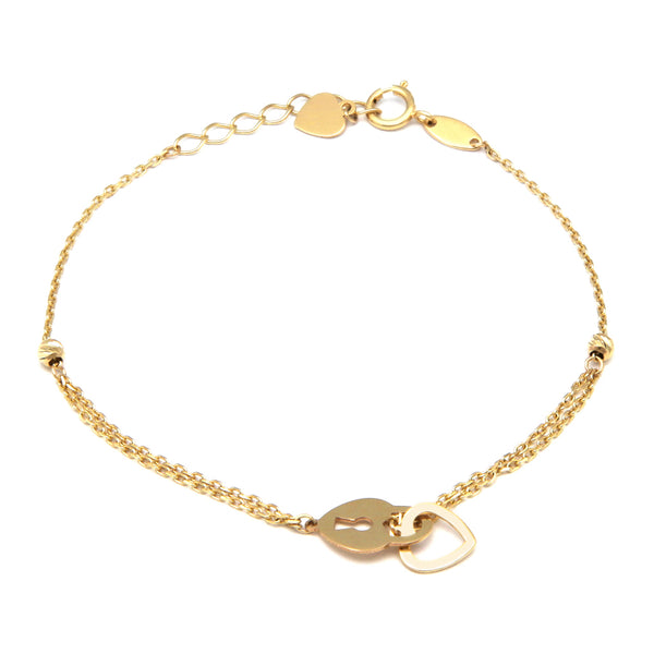 Pulsera eslabón cruzado con aplicaciones y colgante motivo corazón en oro amarillo 14 kilates.