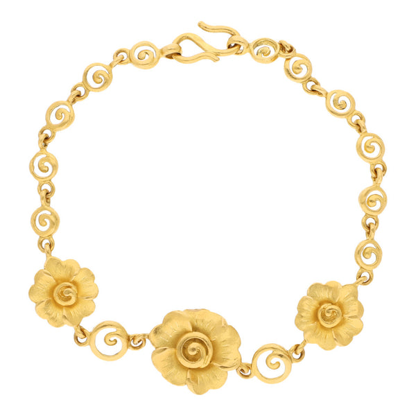 Pulsera eslabón combinado con aplicaciones motivo flor en oro amarillo 24 kilates.