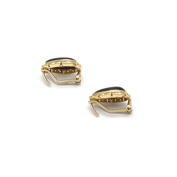 Aretes calados con ojo de tigre black en oro amarillo 14 kilates.