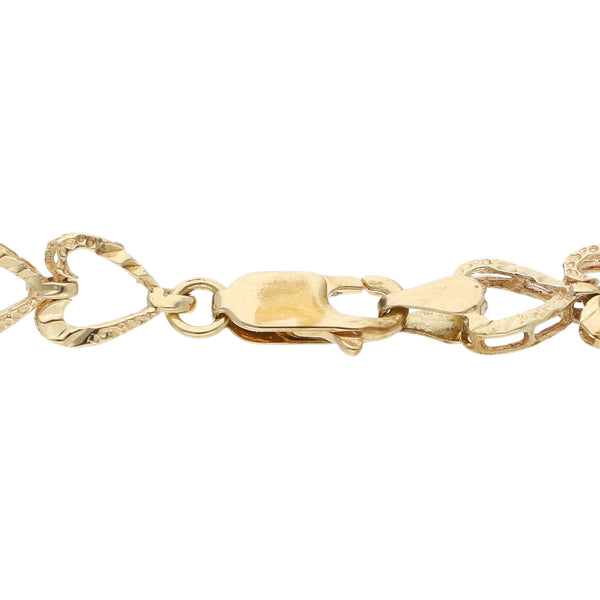 Pulsera eslabón articulado motivo corazón en oro amarillo 14 kilates.