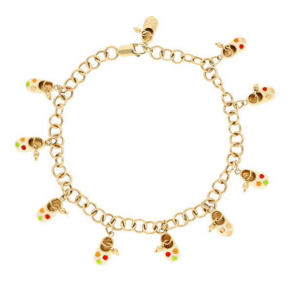 Pulsera eslabón cruzado con colgantes motivo zapatos y esmalte en oro amarillo 14 kilates.