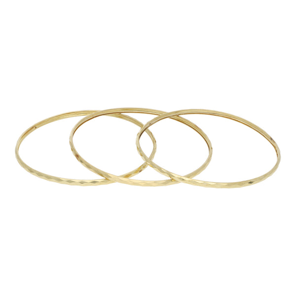 Tres pulseras de arillo facetadas en oro amarillo 12 kilates.