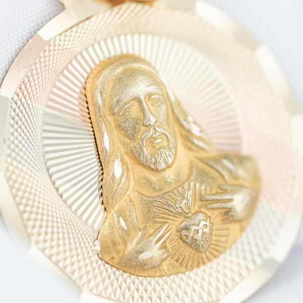 Medalla hechura especial motivo Sagrado Corazón de Jesús en oro amarillo 14 kilates.