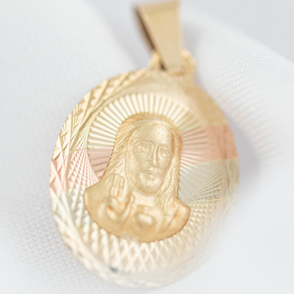 Medalla facetada motivo Sagrado Corazón de Jesús en oro amarillo 14 kilates.