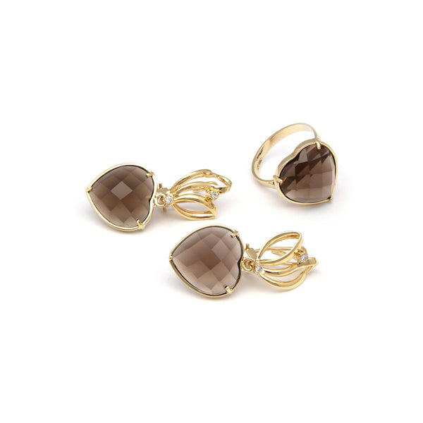 Juego de anillo y aretes estilizados con colgantes de diamantes y topacios en oro amarillo 14 kilates.