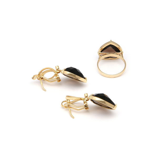 Juego de anillo y aretes estilizados con colgantes de diamantes y topacios en oro amarillo 14 kilates.