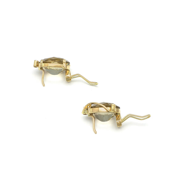 Juego de anillo y aretes calados con topacios y sintéticos en oro amarillo 14 kilates.
