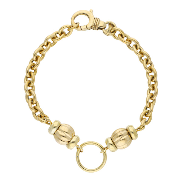 Pulsera eslabón cruzado con aplicaciones en oro amarillo 18 kilates.