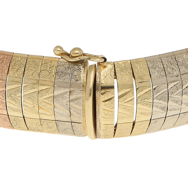 Pulsera eslabón laminado en oro tres tonos 14 kilates.