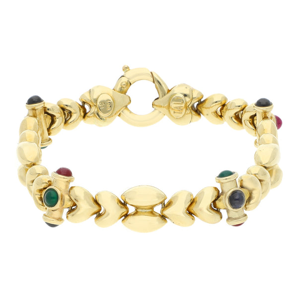 Pulsera eslabón articulado con aplicación motivo corazón y sintéticos en oro amarillo 14 kilates.