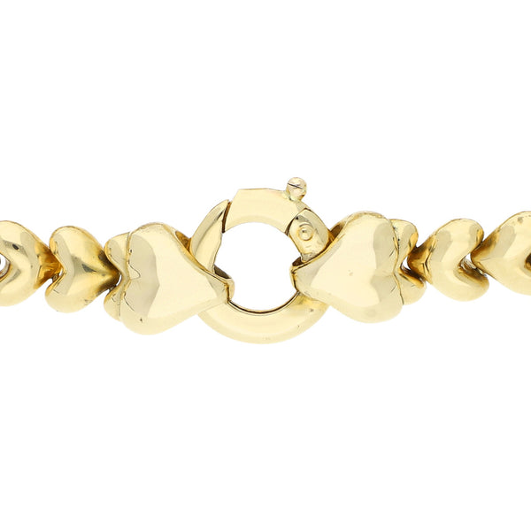 Pulsera eslabón articulado con aplicación motivo corazón y sintéticos en oro amarillo 14 kilates.