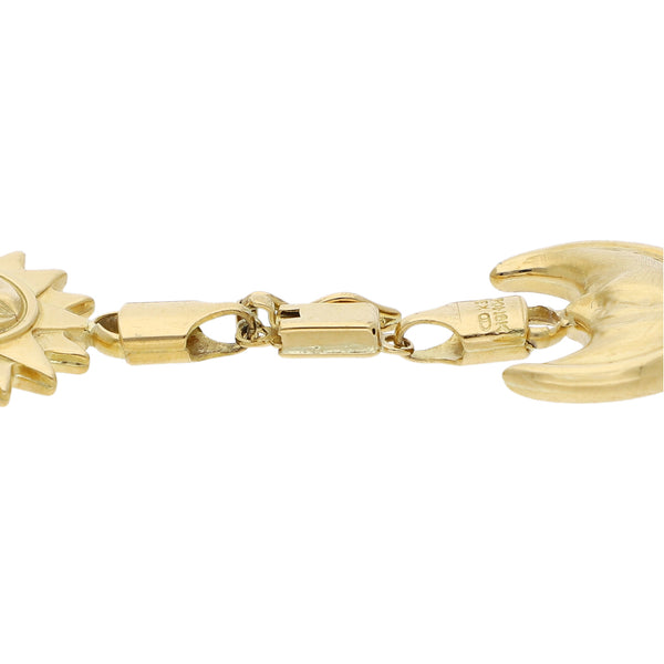 Pulsera eslabón cruzado con aplicaciones sol y luna en oro amarillo 18 kilates.