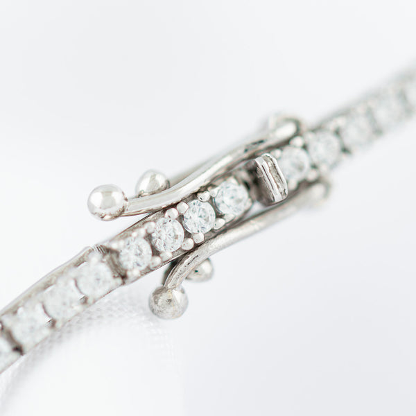 Pulsera eslabón articulado con circonias en oro blanco 14 kilates.