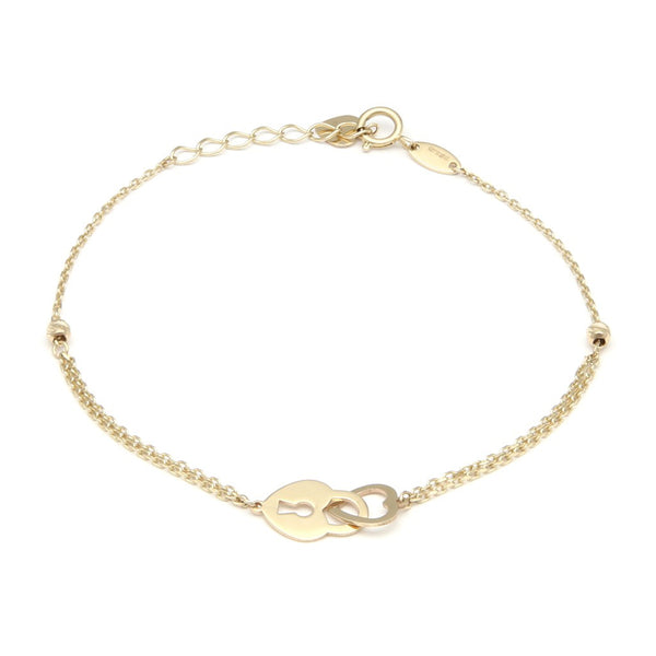 Pulsera eslabón cruzado con aplicaciones motivo corazón y candado de corazón en oro amarillo 14 kilates.