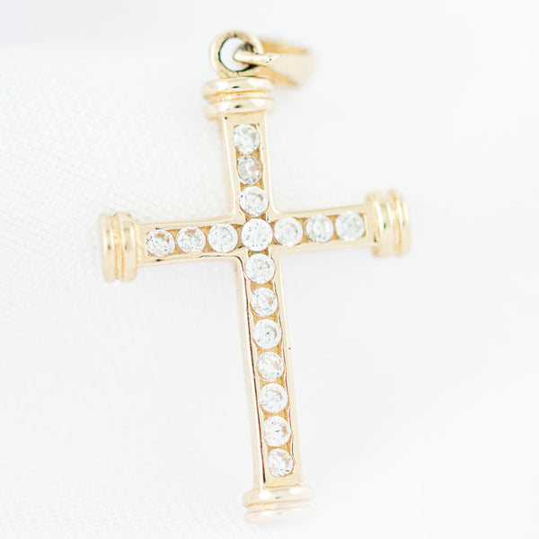 Cruz diseño especial con circonia en oro amarillo 14 kilates.