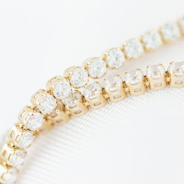 Pulsera eslabón articulado con circonias en oro amarillo 14 kilates.