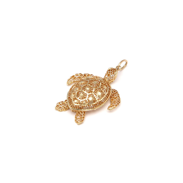 Dije calado motivo tortuga en oro amarillo 14 kilates.