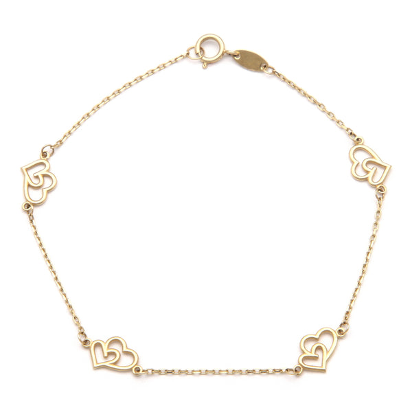 Pulsera eslabón cruzado con aplicación motivo corazón doble en oro amarillo 14 kilates.