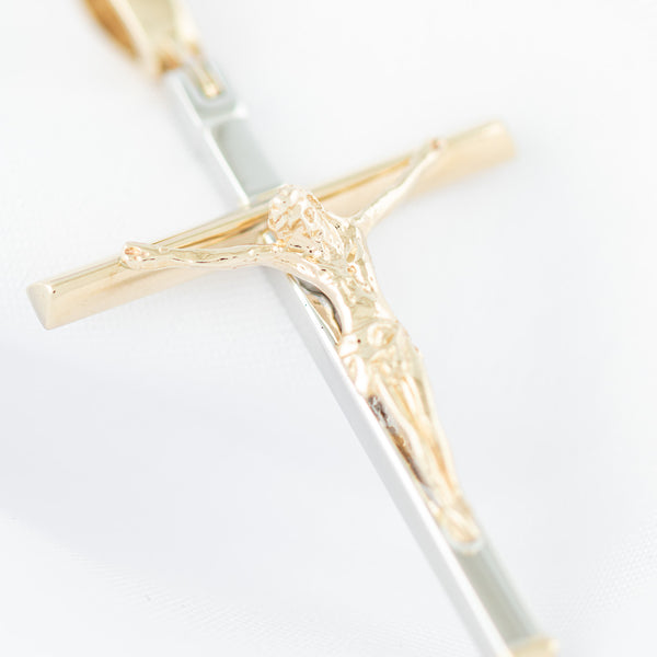 Crucifijo liso en oro dos tonos 14 kilates.