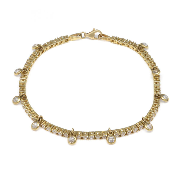 Pulsera eslabón articulado con aplicaciones y colgantes de circonias en oro amarillo 14 kilates.