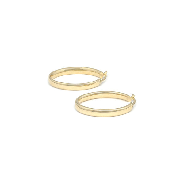 Arracadas lisas huecas en oro amarillo 14 kilates.