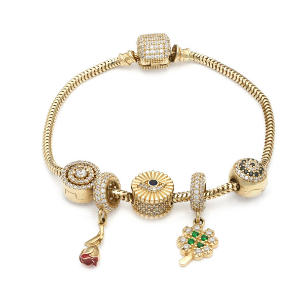 Pulsera eslabón articulado con aplicación y colgantes motivo figuras diferentes con sintéticos y esmalte en oro amarillo 14 kilates.