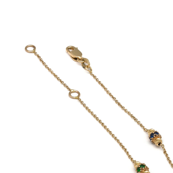 Pulsera eslabón cruzado con aplicaciones y sintéticos en oro amarillo 14 kilates.