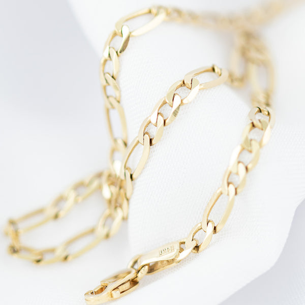 Pulsera de tres eslabones por uno en oro amarillo 14 kilates.