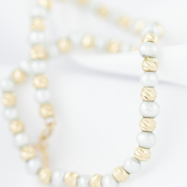 Pulsera eslabón boleado con sintéticos en oro amarillo 14 kilates.