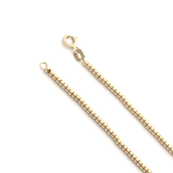 Pulsera eslabón boleado con aplicaciones motivo ojos de sintéticos en oro amarillo 14 kilates.