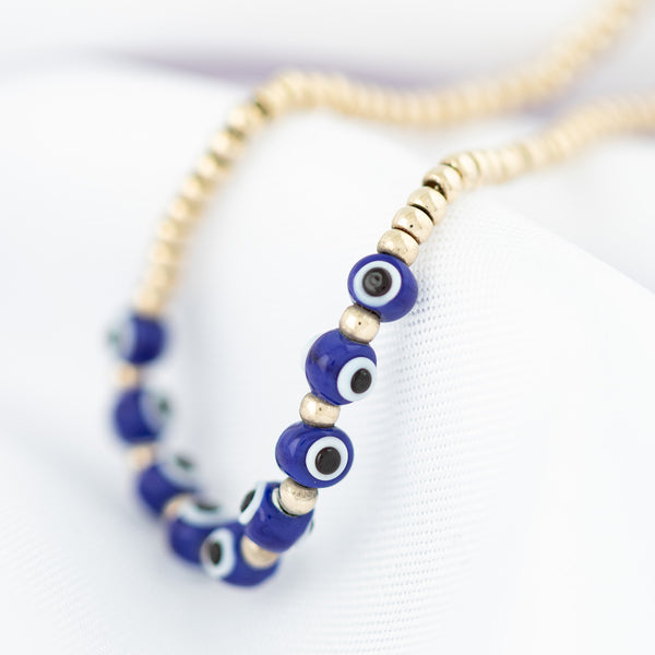 Pulsera eslabón boleado con aplicaciones motivo ojos de sintéticos en oro amarillo 14 kilates.