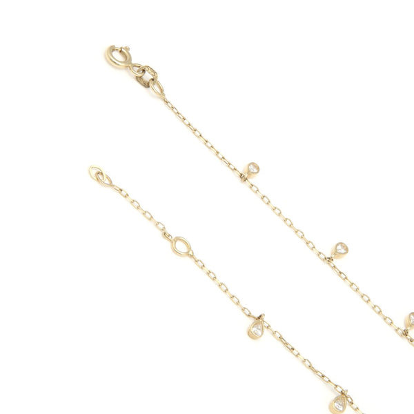 Pulsera eslabón cruzado con colgantes motivo gotas y circonias en oro amarillo 14 kilates.