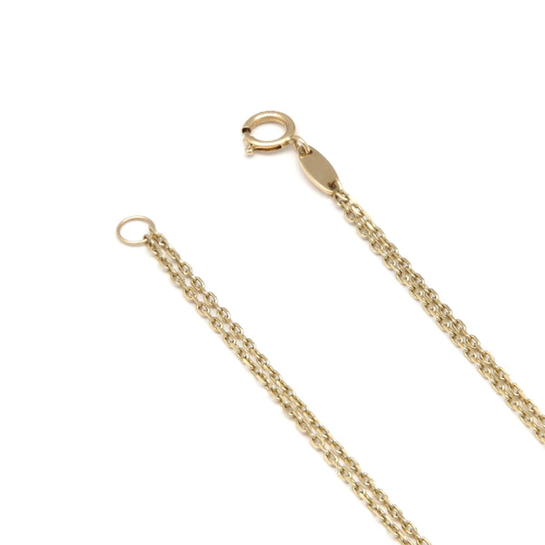Pulsera de dos hilos eslabón cruzado con aplicaciones y sintético en oro amarillo 14 kilates.