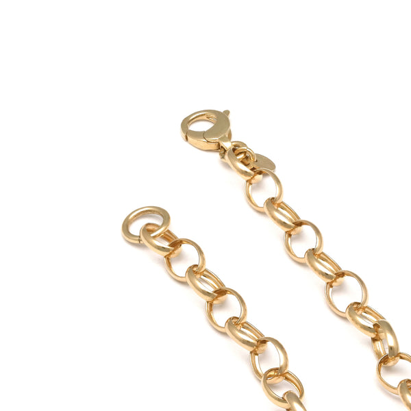 Pulsera eslabón cruzado con colgantes motivo llaves y candado en oro amarillo 14 kilates.