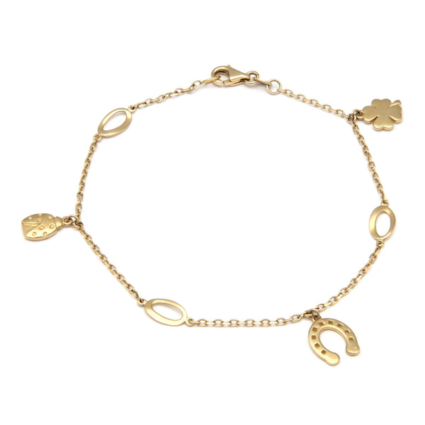 Pulsera eslabón cruzado con aplicaciones y colgantes en oro amarillo 14 kilates.